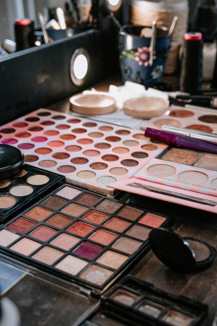 who-we-are A variety of makeup palettes and accessories on a vanity table, perfect for beauty and fashion visuals.