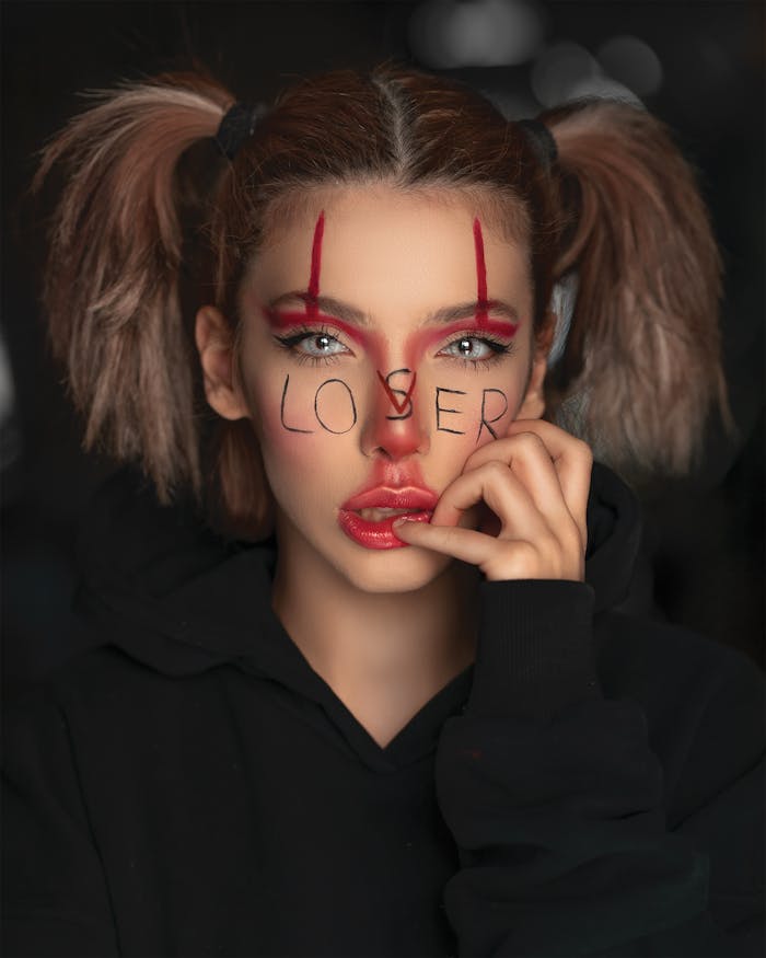 journey Artistic portrait of a woman with eerie Halloween makeup and intense expression.